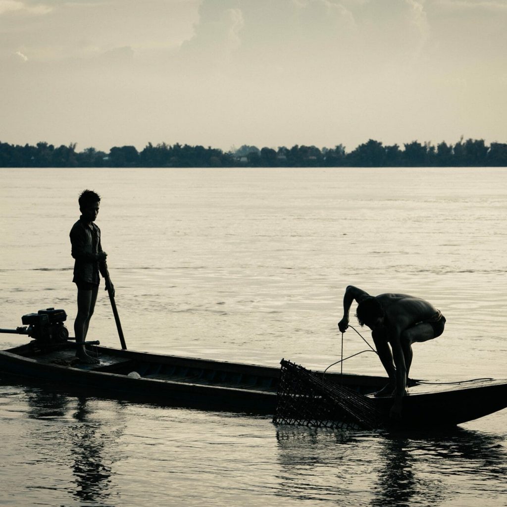 Fisher people work along the Mekong River in Cambodia.