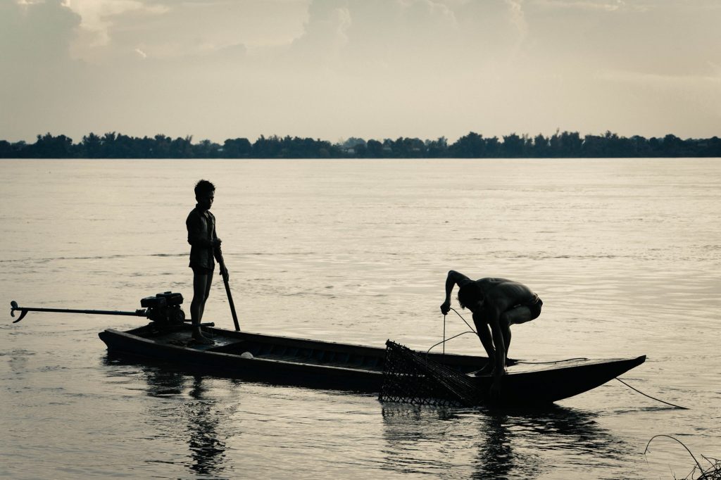 Fisher people work along the Mekong River in Cambodia.