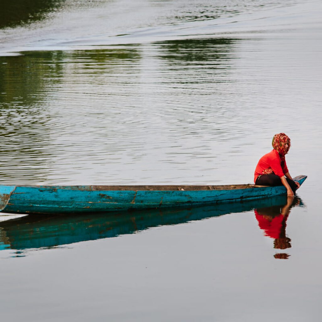 A woman fishing in the Mekong River, Cambodia.