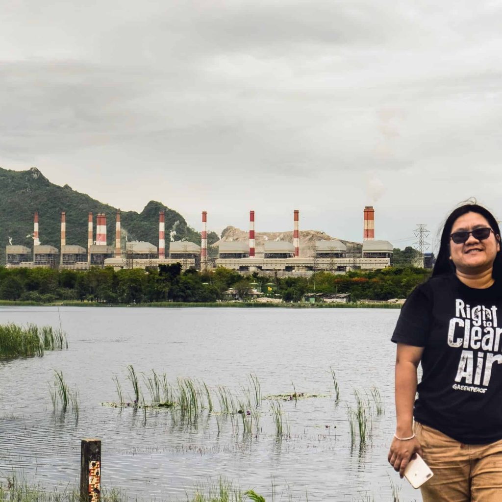 EarthRights International Mekong Legal Bertha Fellow Chompoo in front of the Mae Moh coal-fired power plant.