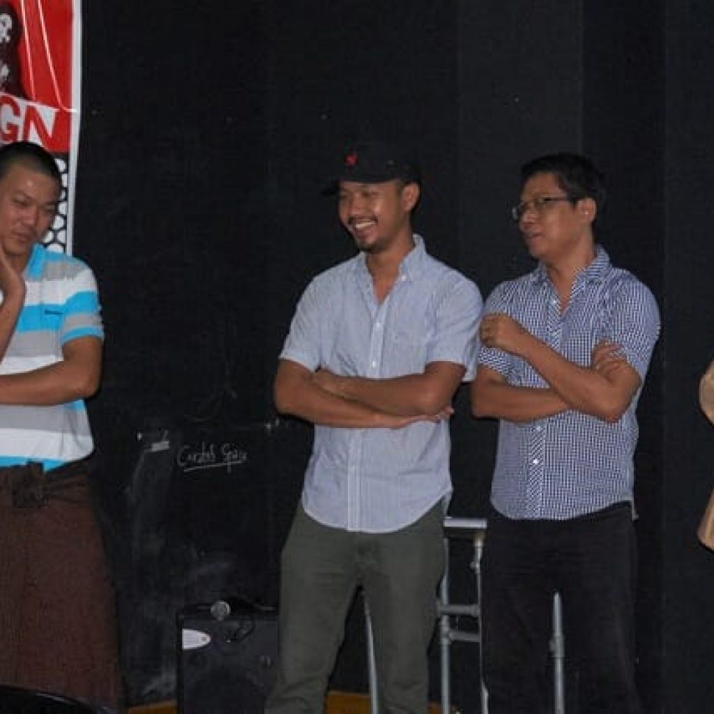 EarthRights Alumni Coordinator Raa Hoo Lar invites the trainers and mentors of EarthRigths Exposures Ko Shan Gyi, Nyi Zaw Htwe and Pe Maung Same to address the participants during the inaugural ERE film screening in Yangon, Myanmar on December 4, 2015.