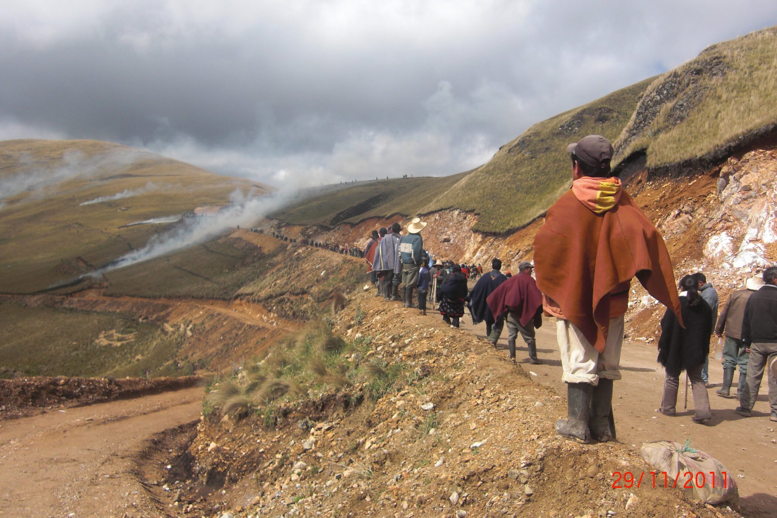 long line of people walking along mountain trail