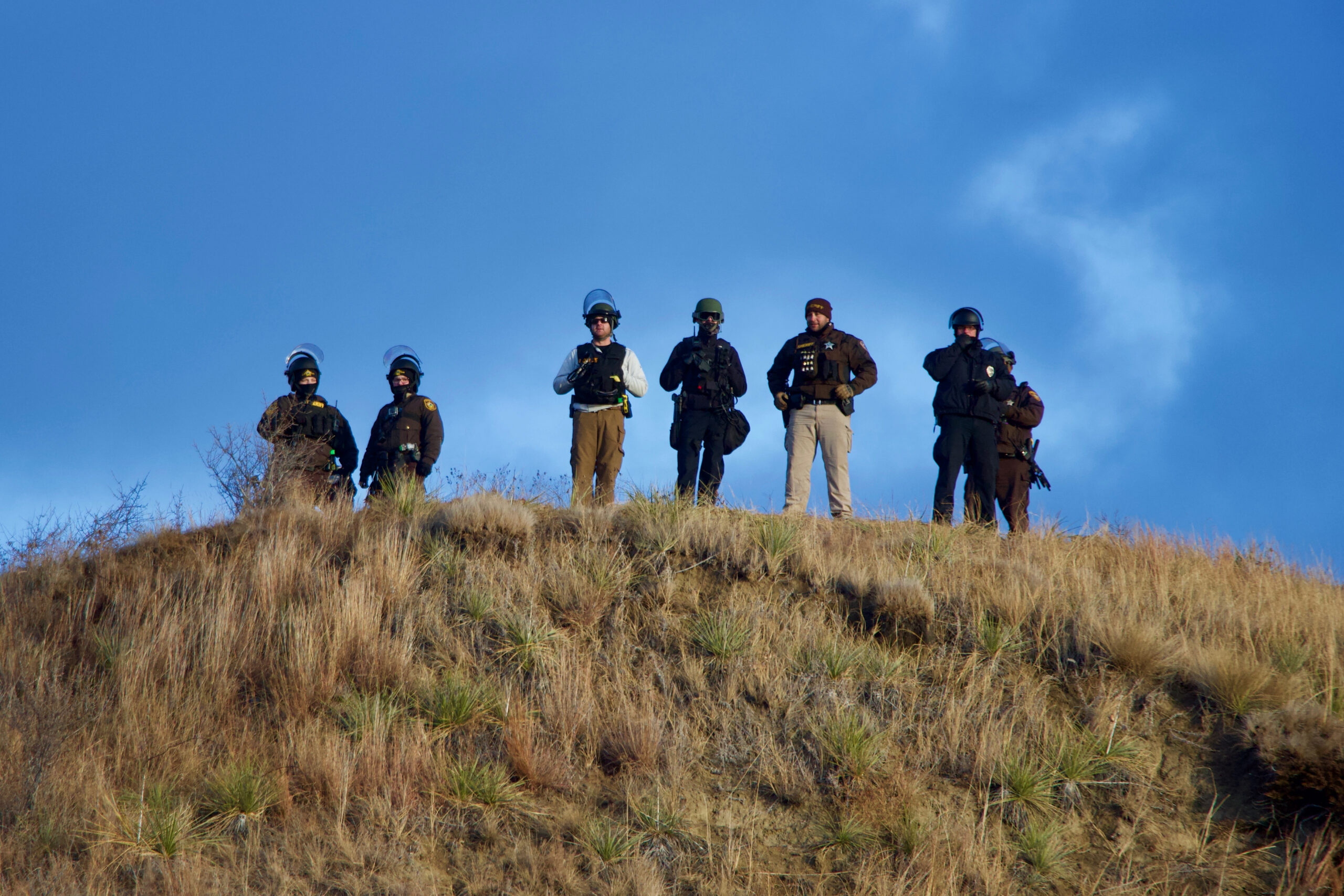 police lined up on a hill