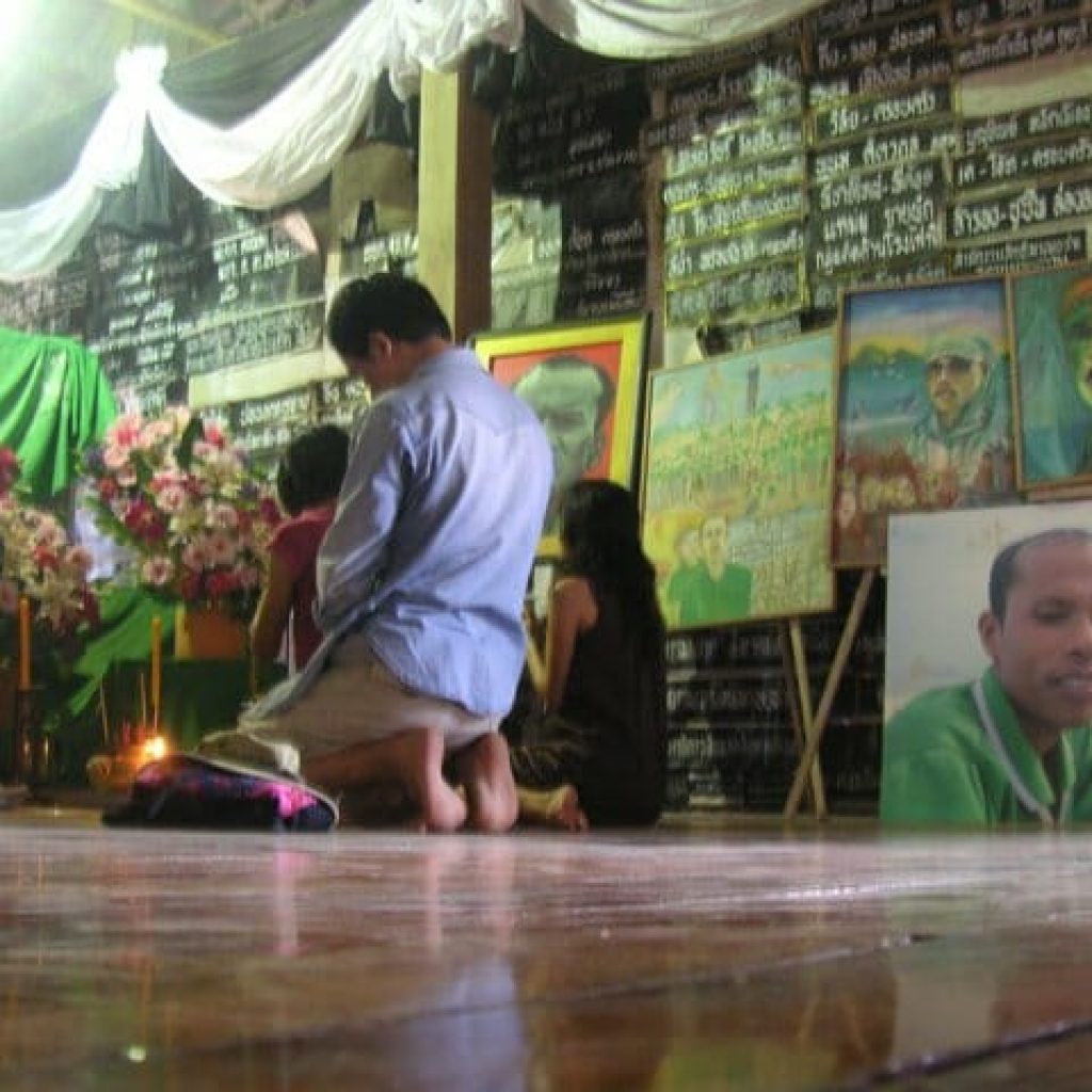 A local temple with signs and paintings memorializing activist Charoen Watakson