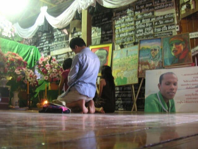 A local temple with signs and paintings memorializing activist Charoen Watakson
