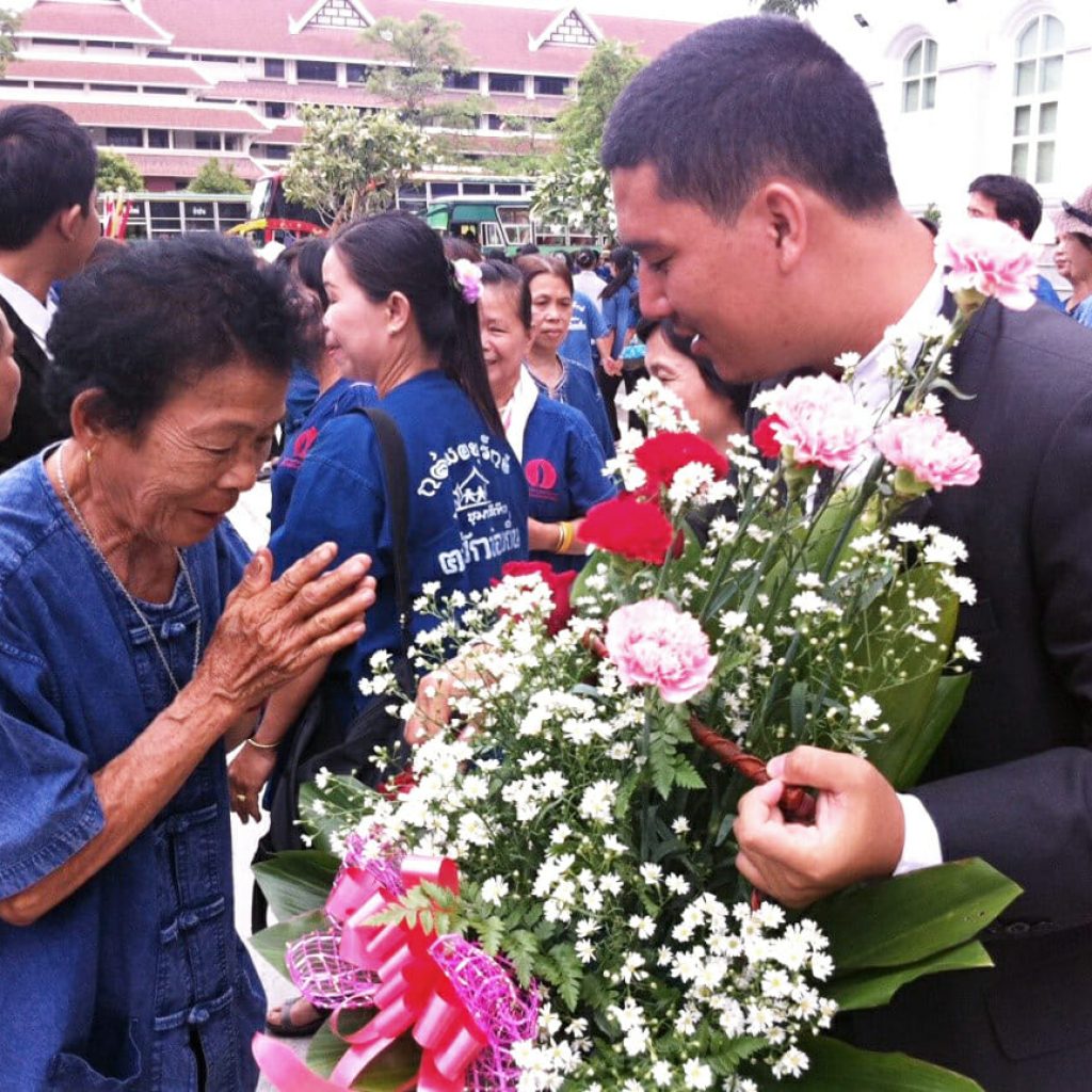A villager thanks his attorney with a gift of flowers